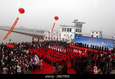 (100411) -- SHANGHAI, April 11, 2010 (Xinhua) -- People attend the welcome ceremony for the triumphant return of the Xuelong (Snow Dragon) icebreaker upon its arrival at the harbour of Shanghai, east China, April 10, 2010. China s 26th Antarctic expedition team aboard the Xuelong (Snow Dragon) icebreaker return to its base in Shanghai Saturday morning after finishing 12 scientific research projects covering remote sensing, icebergs, biology, physics, etc. This expedition had the biggest staff since China started Antarctic missions in 1984. The 249 staff completed more than 50 scientific resear Stock Photo