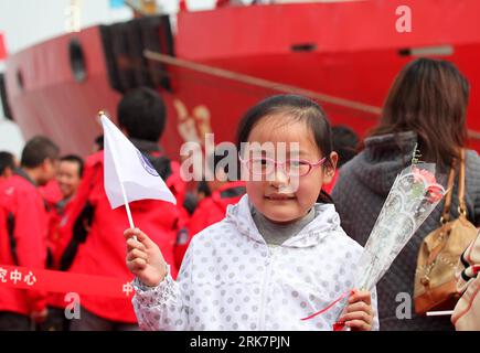 (100411) -- SHANGHAI, April 11, 2010 (Xinhua) -- Liu Yeqin waits to greet her mother Wei Lijie, who is a member of China s 26th Antarctic expedition team, as Xuelong (Snow Dragon) icebreaker arrives at the harbour of Shanghai, east China, April 10, 2010. China s 26th Antarctic expedition team aboard the Xuelong (Snow Dragon) icebreaker return to its base in Shanghai Saturday morning after finishing 12 scientific research projects covering remote sensing, icebergs, biology, physics, etc. This expedition had the biggest staff since China started Antarctic missions in 1984. The 249 staff complete Stock Photo