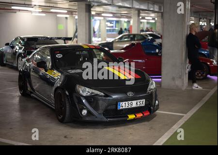 Front view of a black Toyota GT86 Japanese sports car with colored stripes parked in the underground parking Stock Photo