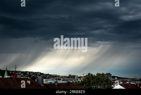 Stuttgart, Germany. 24th Aug, 2023. Dark clouds and rain clouds pass over Stuttgart. After the heat, thunderstorms and rain showers may also occur on Friday. Credit: Christoph Schmidt/dpa/Alamy Live News Stock Photo