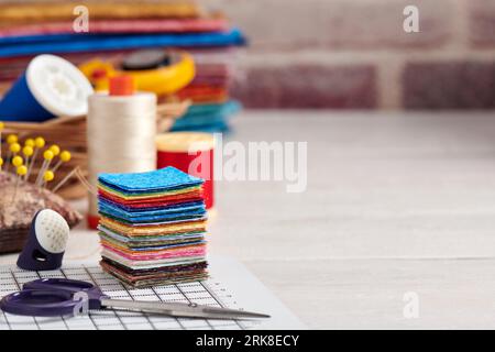Stack of square pieces of colorful fabrics, accessories for quilting Stock Photo