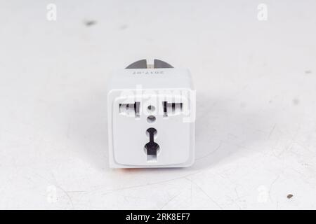 Close up of universal electric socket plug adapters, isolated on white background. Used to connect electrical outlets worldwide. Concept of solution, Stock Photo