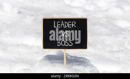 Boss vs leader symbol. Concept words Boss vs versus leader on beautiful black chalk blackboard. Beautiful snow background. Business motivational boss Stock Photo