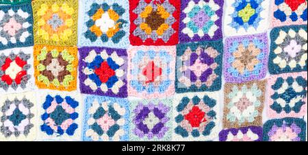 Multi colored blanket in wool, geometric background, retro decorative pattern Stock Photo