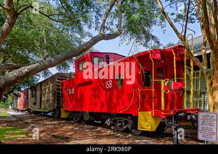 A Louisville and Nashville Railroad caboose sits outside the historic Foley Train Depot, which now houses the Foley Railroad Museum in Foley, Alabama. Stock Photo