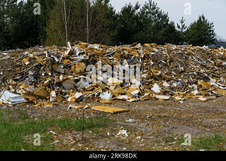 Pile of industrial synthetic waste in the forest area. Camera movement from left to right. Stock Photo