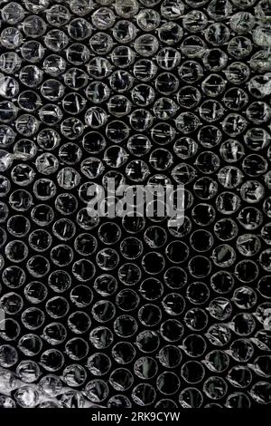 Black bubble plastic wrap surface. plastic with air balls on the surface used to pack glassware or electronics or sensitive items Stock Photo