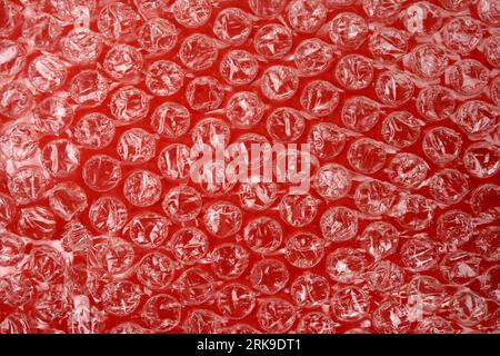 Red bubble plastic wrap surface. plastic with air balls on the surface used to pack glassware or electronics or sensitive items Stock Photo