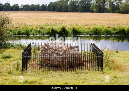 The only remaining block of masonry sitting on the site of Fotheringhay Castle which was dismantled in 1628. The historic castle was part of two major moments in English history. King Richard III was born at Fotheringhay in October 1452. Mary Queen of Scots was held prisoner and executed at Fotheringhay in February 1587. The remaining stones sit beside the River Nene in the County of Northamptonshire. Stock Photo