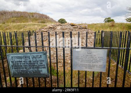 The only remaining block of masonry sitting on the site of Fotheringhay Castle which was dismantled in 1628. The historic castle was part of two major moments in English history. King Richard III was born at Fotheringhay in October 1452. Mary Queen of Scots was held prisoner and executed at Fotheringhay in February 1587. The remaining stones sit beside the River Nene in the County of Northamptonshire. Stock Photo