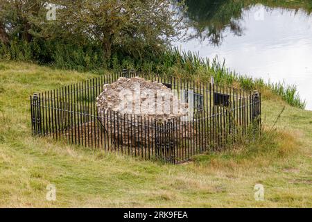 The only remaining block of masonry sitting on the site of Fotheringhay Castle which was dismantled in 1628. The historic castle was part of two major moments in English history. King Richard III was born at Fotheringhay in October 1452. Mary Queen of Scots was held prisoner and executed at Fotheringhay in February 1587. The remaining stones sit beside the River Nene in the County of Northamptonshire. Stock Photo