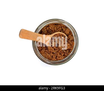Raw Cane Sugar in a jar isolated on white background. Pile of dark brown soft sugar, isolated . Natural dark muscovado, top view. Stock Photo