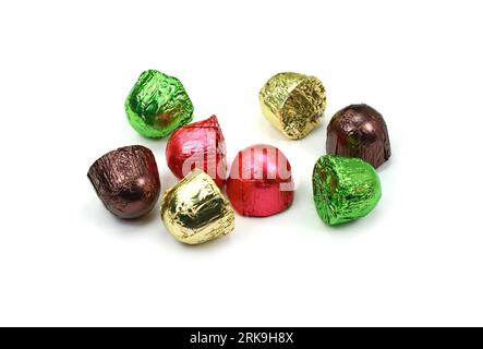 Chocolates in a multi-colored foil isolated on white background Stock Photo