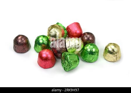 Chocolates in a multi-colored foil isolated on white background Stock Photo