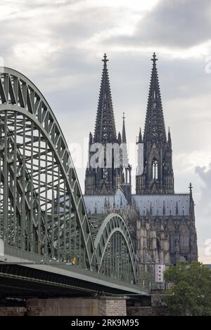 Cologne Cathedral and Hohenzollern Bridge beside the River Rhine, two iconic landmarks in Cologne, Germany. Stock Photo