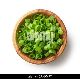 wooden bowl of chopped green onions isolated on white background, top view Stock Photo