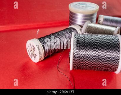 Spools of metallic variegated sewing thread, USA Stock Photo