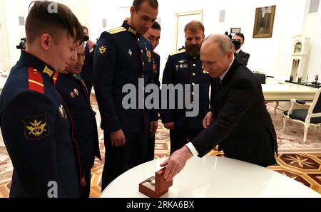 Moscow, Russia. 24th Aug, 2023. Russian President Vladimir Putin, right, presents watches as gifts to the Alyosha T-80 tank crew who destroyed a Ukrainian armored column at the Kremlin, August 24, 2023 in Moscow, Russia. Credit: Mikhail Klimentyev/Kremlin Pool/Alamy Live News Stock Photo