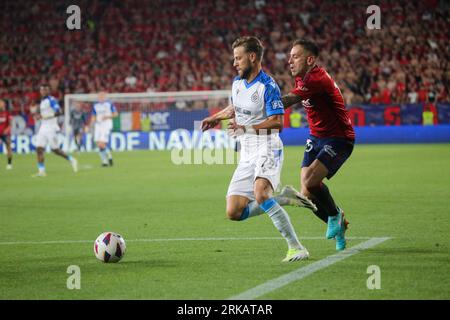 Pamplona, Spain, 24th August, 2023: Club Brugge player Philip Zinckernagel (77, L) with the ball against Ruben Peña (15, R) during the first leg of the previous round of the UEFA Europa Conference League 2023- 24 between CA Osasuna and Club Brugge at the El Sadar Stadium, in Pamplona, on August 24, 2023. Credit: Alberto Brevers / Alamy Live News. Stock Photo