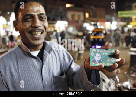 Bildnummer: 54680733  Datum: 26.11.2010  Copyright: imago/Xinhua (101126) -- CAIRO, Nov. 26, 2010 (Xinhua) -- A man shows the card of Mohamed Fiqi of the ruling National Democratic Party (NDP) during his campaign for the upcoming Peoples Assembly (parliament) elections in Cairo, Egypt, Nov. 26, 2010. A total of 508 seats will be contested in the election on Nov. 28, with an additional 10 seats appointed by the president. According to Egypt s High Elections Commission, 5,720 candidates submitted applications for running in the vote. The contesting parties include the ruling National Democratic Stock Photo