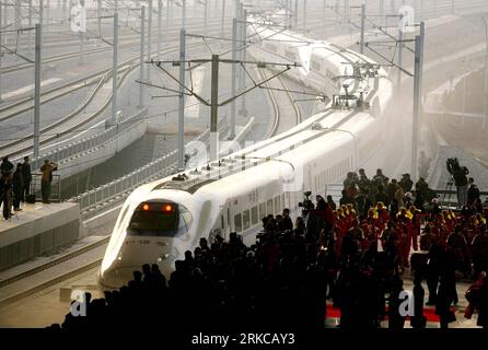 BEIJING Xinhua -- Photo taken on Dec. 26, 2009 shows a train G1001 setting out from Wuhan Railway Station in Wuhan, capital of central China s Hubei Province. The Wuhan-Guangzhou high-speed railway, which boasts of the journey with a 350km per hour average speed, was debuted on that day. China operated a high-speed railway network with a combined length of 7,531 kilometers, the world s longest, said Chinese Railways Minister Liu Zhijun Tuesday while addressing the seventh World Congress on High Speed Rail held in Beijing, December 7, 2010. Liu said China s high-speed railways have been operati Stock Photo