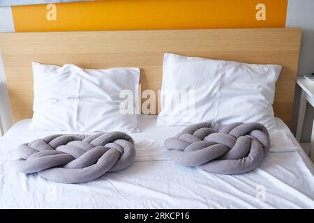 gray color pillow on white bed at living room  Stock Photo