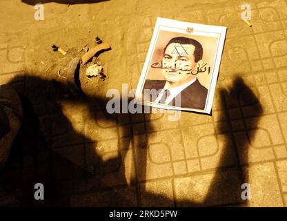 110130 -- CAIRO, Jan. 30, 2011 Xinhua -- The portrait of Egyptian President Hosni Mubarak is abandoned on a street during a protest in Cairo, capital of Egypt, Jan. 30, 2011. Anti-government protests persisted for the sixth day across Egypt on Sunday as demonstrators demanded the ouster of President Hosni Mubarak. The curfew ordered by the Egyptian government, previously from 4 p.m. to 8 a.m., now runs from 3 p.m. 1300 GMT to 8 a.m. Xinhua/Cai Yang wjd EGYPT-CAIRO-PROTESTS PUBLICATIONxNOTxINxCHN Stock Photo
