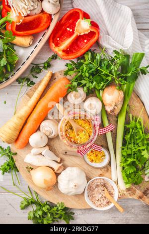 Homemade vegetable broth powder, organic vegetable stock, with raw vegetables, mushrooms and herbs Stock Photo