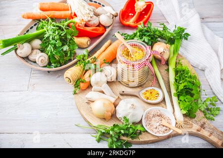 Homemade vegetable broth powder, organic vegetable stock, with raw vegetables, mushrooms and herbs Stock Photo