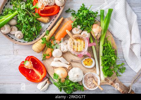 Homemade vegetable broth powder, organic vegetable stock, with raw vegetables, mushrooms and herbs Stock Photo