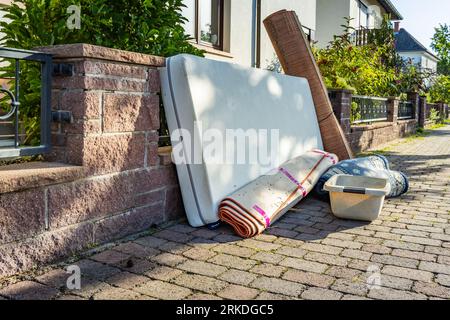 Bulk garbage day concept, miscellaneous rubbish items put on a street for council bulk waste collection, bulky waste and waste management Stock Photo