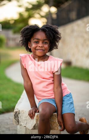 African Amerian little girl smiling outside Stock Photo - Alamy
