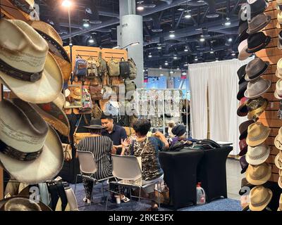 Las Vegas, USA. 20th Aug, 2023. People negotiate at a booth during the Las Vegas ASD Market Week in Las Vegas, the United States, Aug. 20, 2023. The number of exhibitors at the Las Vegas ASD Market Week is similar to that of the past, but many wholesalers attending the trade show said they feel depressed and helpless as traffic flow and transaction activity have dropped significantly this year.TO GO WITH 'Roundup: U.S. wholesalers say decoupling damages business deeply' Credit: Huang Heng/Xinhua/Alamy Live News Stock Photo