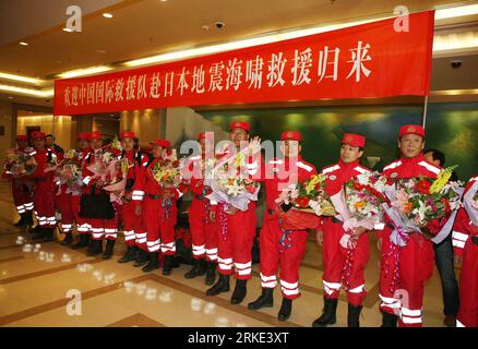 Bildnummer: 55048036  Datum: 21.03.2011  Copyright: imago/Xinhua BEIJING, March 21, 2011 (Xinhua) -- Crew members of the Chinese International Search and Rescue Team (CISAR) are seen during a welcome-home ceremony at the Capital Airport in Beijing, capital of China, March 21, 2011. The Chinese rescue team returned to the Chinese capital from Japan at midnight Sunday, after conducting search and rescue missions in the quake-hit country. (Xinhua/Li Fangyu) (ljh) CHINA-BEIJING-CISAR-ARRIVAL (CN) PUBLICATIONxNOTxINxCHN Gesellschaft Japan Naturkatastrophe Erdbeben Tsunami Rettung Rettungskräfte Rüc Stock Photo