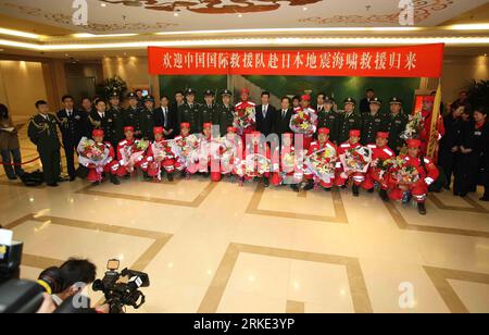 Bildnummer: 55048033  Datum: 21.03.2011  Copyright: imago/Xinhua BEIJING, March 21, 2011 (Xinhua) -- Crew members of the Chinese International Search and Rescue Team (CISAR) pose for group photos during a welcome-home ceremony at the Capital Airport in Beijing, capital of China, March 21, 2011. The Chinese rescue team returned to the Chinese capital from Japan at midnight Sunday, after conducting search and rescue missions in the quake-hit country. (Xinhua/Li Fangyu) (ljh) CHINA-BEIJING-CISAR-ARRIVAL (CN) PUBLICATIONxNOTxINxCHN Gesellschaft Japan Naturkatastrophe Erdbeben Tsunami Rettung Rettu Stock Photo