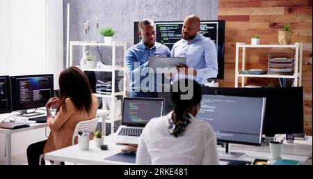 African Business Team Working On Computer. Software App Development Stock Photo