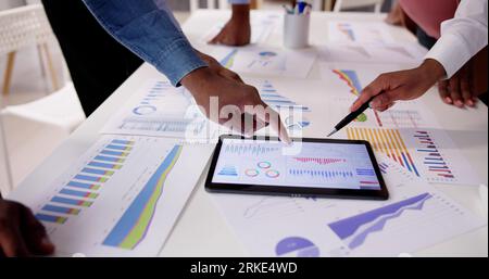 Financial Report Graph Analysis On Tablet In Business Meeting Stock Photo