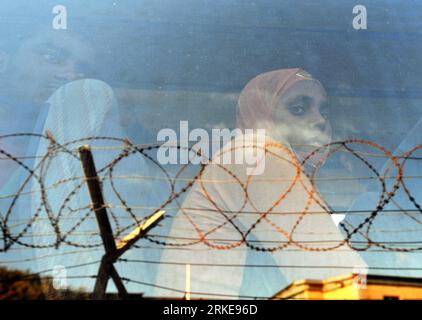 (110330) -- LAMPEDUSA, March 30, 2011 (Xinhua) -- Illegal immigrants from North Africa depart from a refugee center on Lampedusa island, southernmost Italy, March 29, 2011. Some 18,000 North African immigrants, mainly from unrest-torn Libya and Tunisia, have been flooding the small Italian island of Lampedusa, which is only 110 km away from Africa. More immigrants are expected to land here as the Libyan crisis deepens. Italy will send more ships with a total capacity of 10,000 berths to evacuate migrants on Lampedusa starting from Wednesday. (Xinhua/Wang qingqin) (yc) ITALY-LAMPEDUSA-NORTH AFR Stock Photo