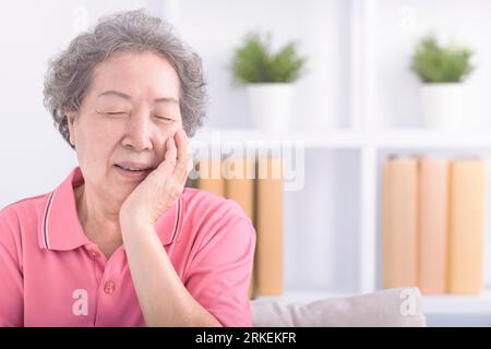 Asian senior aged woman with toothache Stock Photo