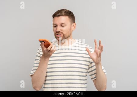Middle aged man records voice message. Voice communication in instant messengers.  Stock Photo
