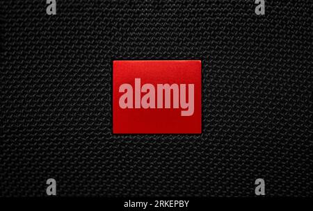 Red Stop button. Futuristic play button on a black textile window background Stock Photo