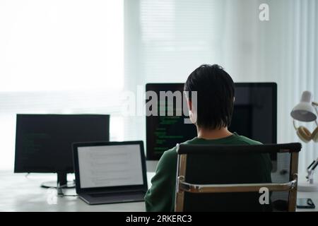 Software developer programming on computer at his office desk Stock Photo