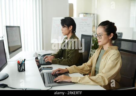 Software developers working on computers on new big project Stock Photo