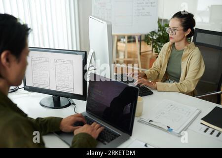 Front end developers working on website for new project Stock Photo