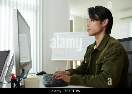 Portrait of serious software developer concentrated on reviewing programming code Stock Photo