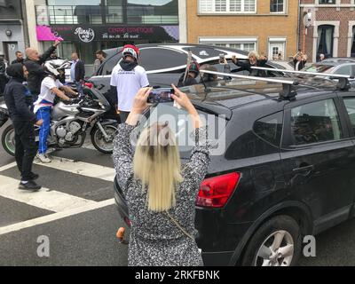 Herstal, Belgium. 25th Aug, 2023. People with bikes and in cars and some wearing shirts that reads 'Justice pour Drom's' are seen outside the church, after the funeral ceremony for the young man shot dead by the police on 18 August in Oupeye after running over a policeman with his quad bike, Friday 25 August 2023 in Herstal. BELGA PHOTO Credit: Belga News Agency/Alamy Live News Stock Photo