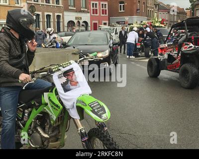 Herstal, Belgium. 25th Aug, 2023. People with bikes and in cars and some wearing shirts that reads 'Justice pour Drom's' are seen outside the church, after the funeral ceremony for the young man shot dead by the police on 18 August in Oupeye after running over a policeman with his quad bike, Friday 25 August 2023 in Herstal. BELGA PHOTO Credit: Belga News Agency/Alamy Live News Stock Photo