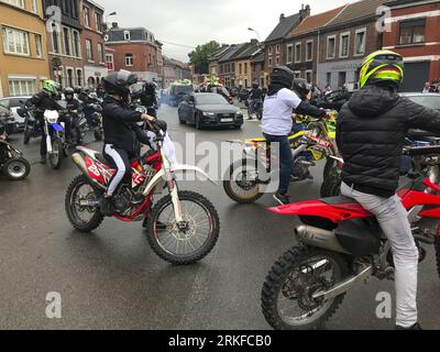 Herstal, Belgium. 25th Aug, 2023. People with bikes and in cars and some wearing shirts that reads 'Justice pour Drom's' are seen outside the church, after the funeral ceremony for the young man shot dead by the police on 18 August in Oupeye after running over a policeman with his quad bike, Friday 25 August 2023 in Herstal. BELGA PHOTO Credit: Belga News Agency/Alamy Live News Stock Photo