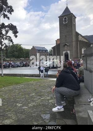 Herstal, Belgium. 25th Aug, 2023. People wait outside during the funeral ceremony for the young man shot dead by the police on 18 August in Oupeye after running over a policeman with his quad bike, Friday 25 August 2023 in Herstal. BELGA PHOTO Credit: Belga News Agency/Alamy Live News Stock Photo