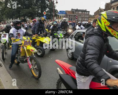 Herstal, Belgium. 25th Aug, 2023. People with bikes and in cars and some wearing shirts that reads 'Justice pour Drom's' are seen outside the church, after the funeral ceremony for the young man shot dead by the police on 18 August in Oupeye after running over a policeman with his quad bike, Friday 25 August 2023 in Herstal. BELGA PHOTO Credit: Belga News Agency/Alamy Live News Stock Photo